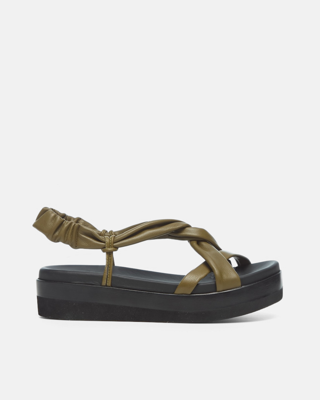 Side view of a sandal featuring a thick black platform sole, olive green leather straps with a crisscross design, and an elasticized back strap for a secure fit.