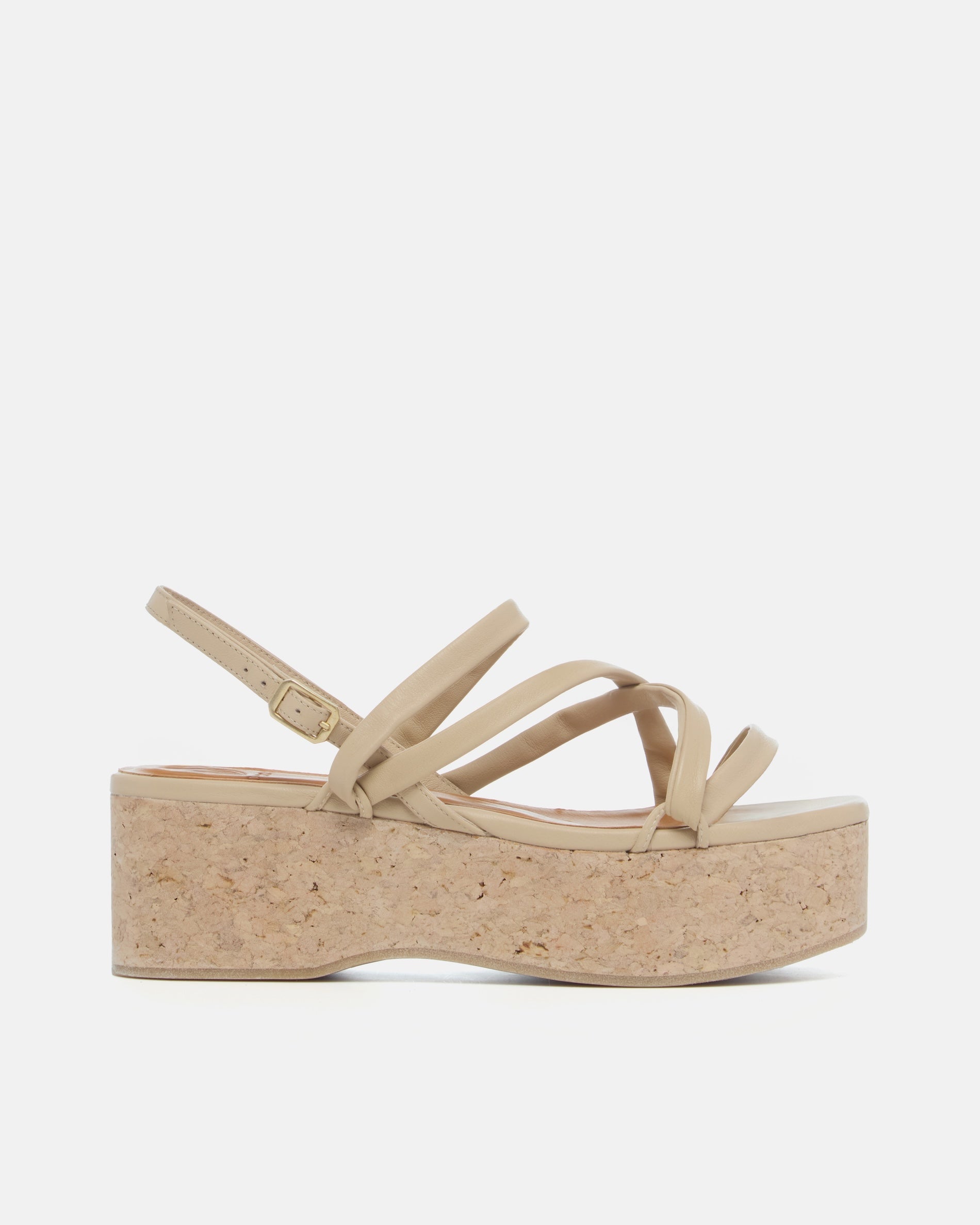 Side view of a off-white leather cork wedge sandal with slim crisscross straps, adjustable slingback, and a sculptural cork platform sole