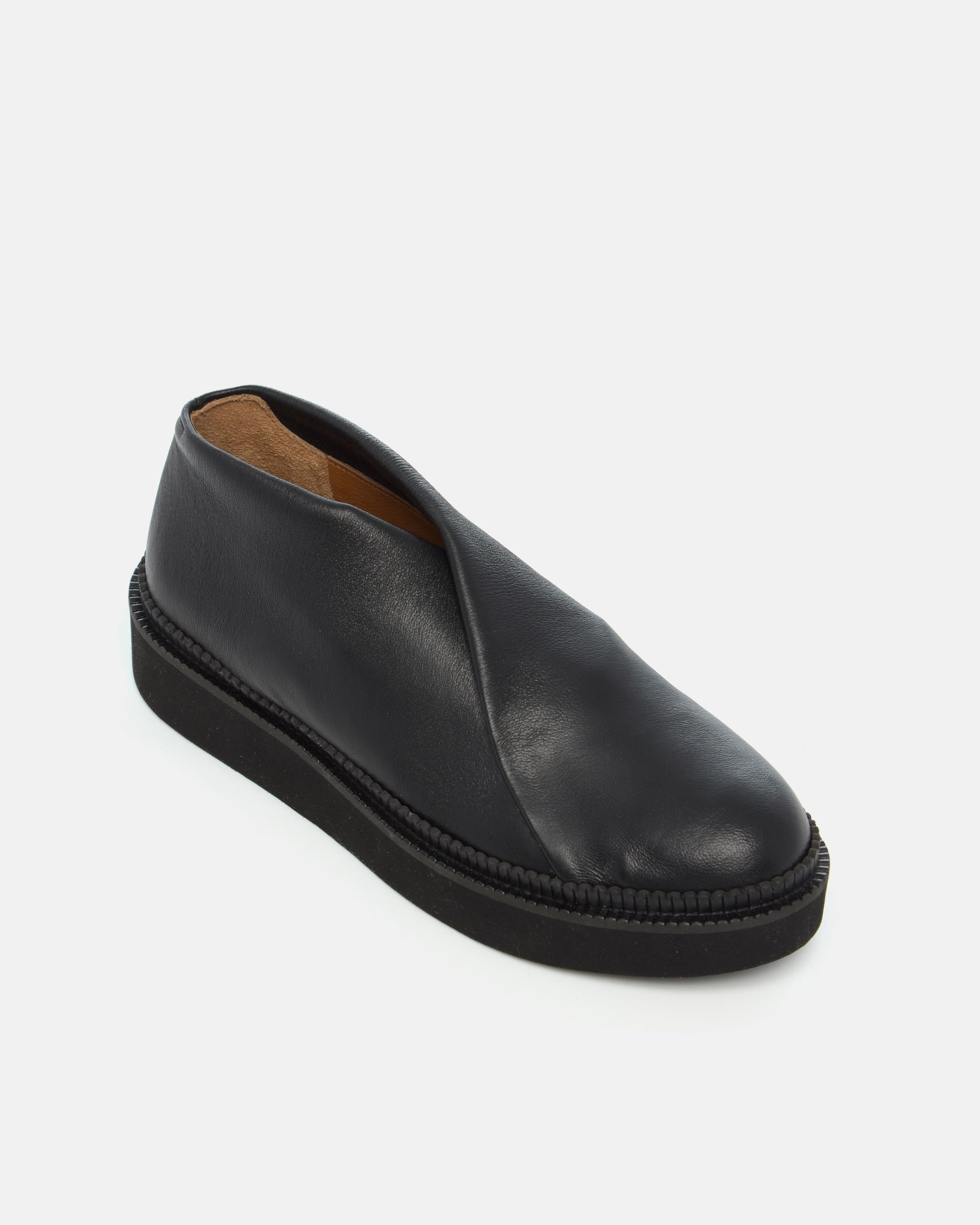 Coclico Grace Flatform in black stretch leather, angled view of the wrapped vamp and platform sole