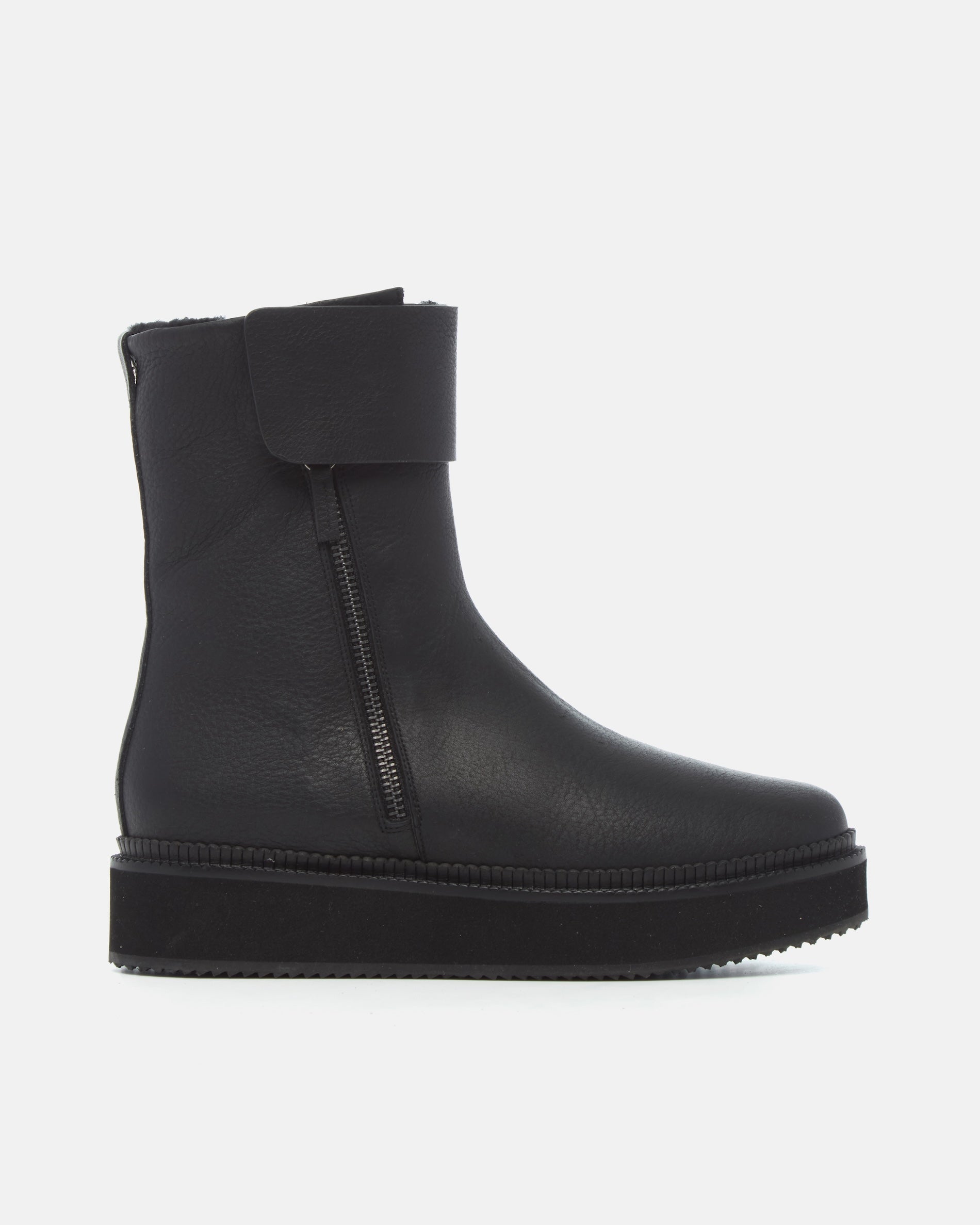 Coclico Greer Shearling Boot in black leather, side view of a flat ankle boot with platform sole