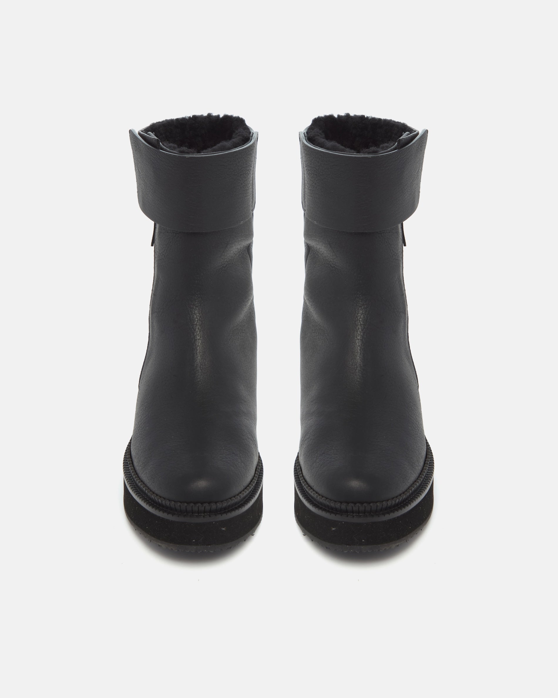 Pair of Coclico Greer Shearling Boots in black leather with shearling lining, front view