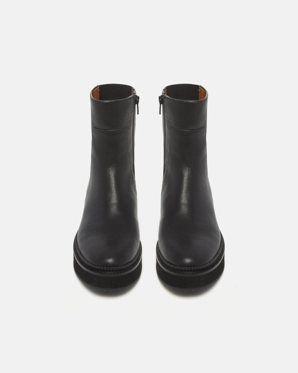 Pair of Coclico Greta Boots in black leather, front view of flat platform ankle boots