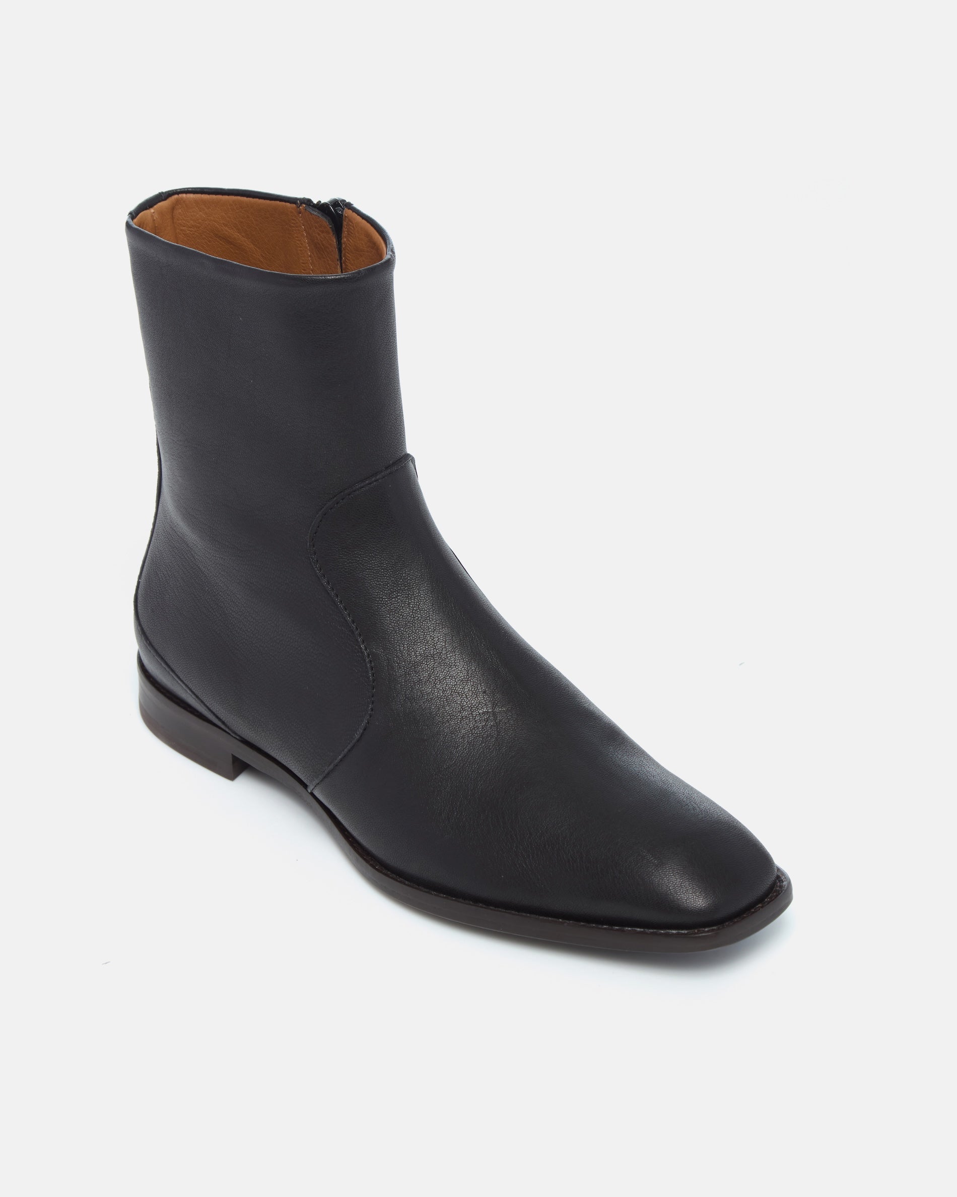 Coclico Hopper Boot in black leather, angled view of the square toe and flat sole