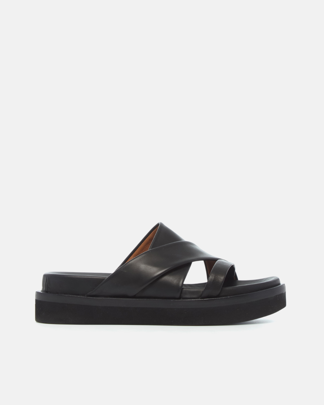 Side view of a black leather footbed sandal with wide folded straps and a sleek cushioned platform sole
