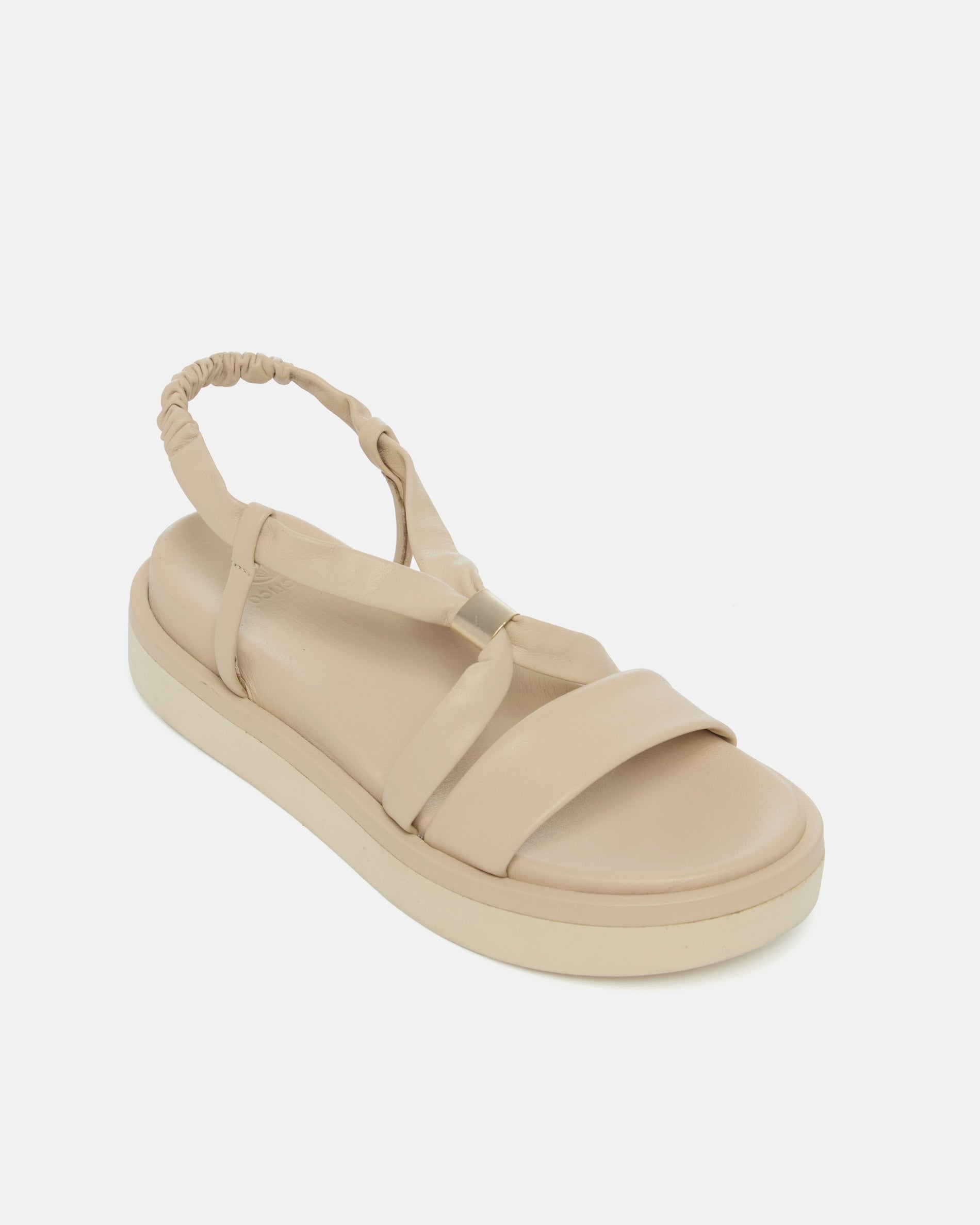 Angled view of a milky white leather slingback footbed sandal with soft tubular straps, brushed-metal keeper detail, and a cushioned platform sole on a white background