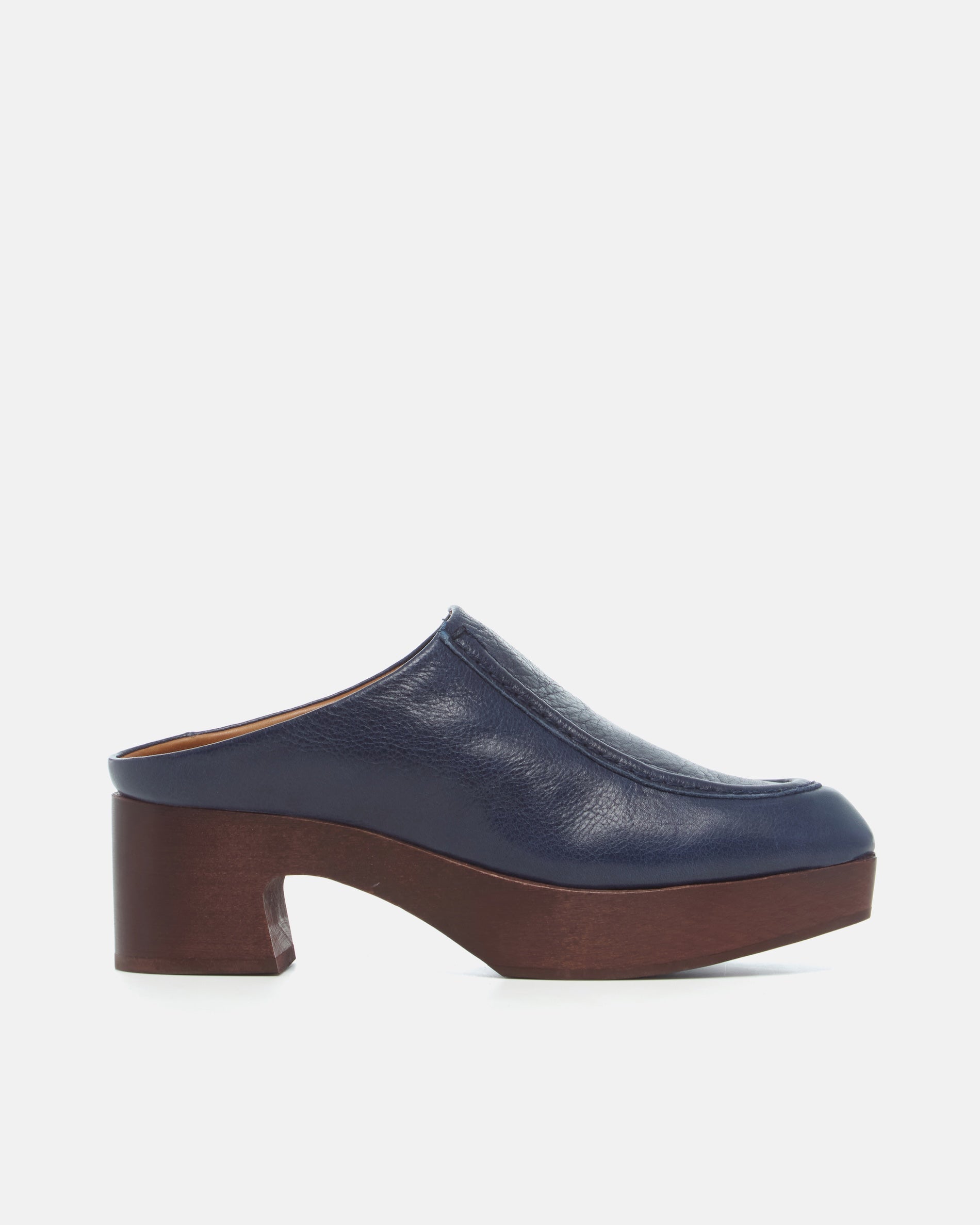 Coclico Qadira Clog in Marino navy leather, side view of a clog mule with wooden tone platform heel