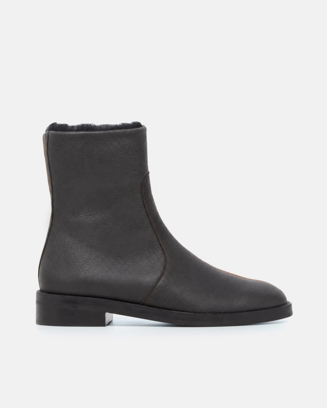 Black leather ankle boot with a low heel and a soft black shearling lining shown in a side profile on a light gray background.
