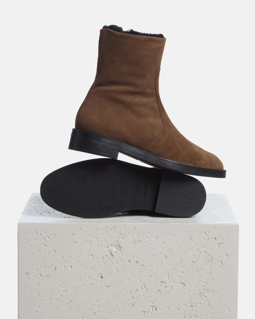 Coclico Theo Shearling Boot in Cowgirl split suede, shearling lined ankle boots styled on a stone plinth