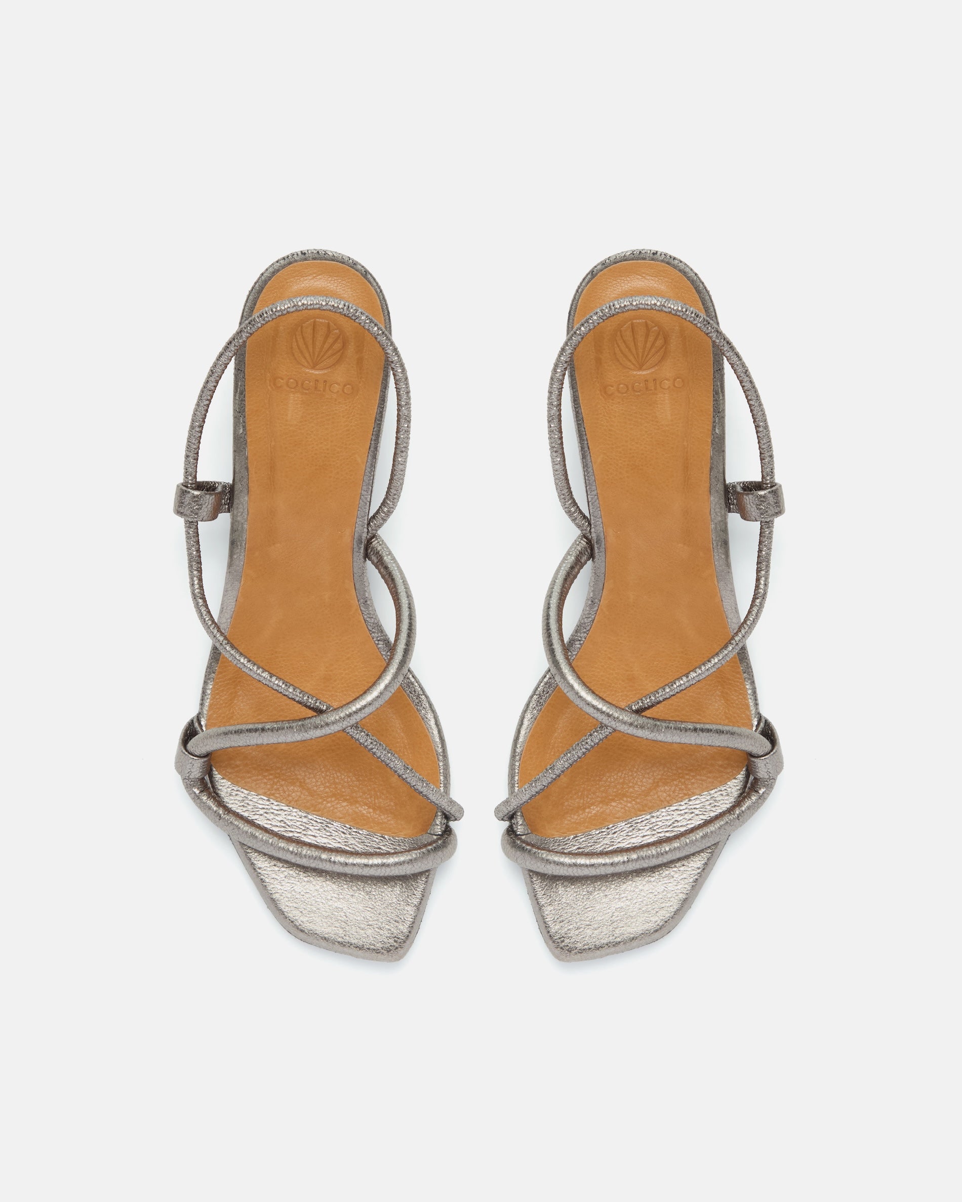 Top view of a metallic pewter leather mid-heel sandal with slim crossover straps, an elastic slingback, and a softly contoured demi heel.
