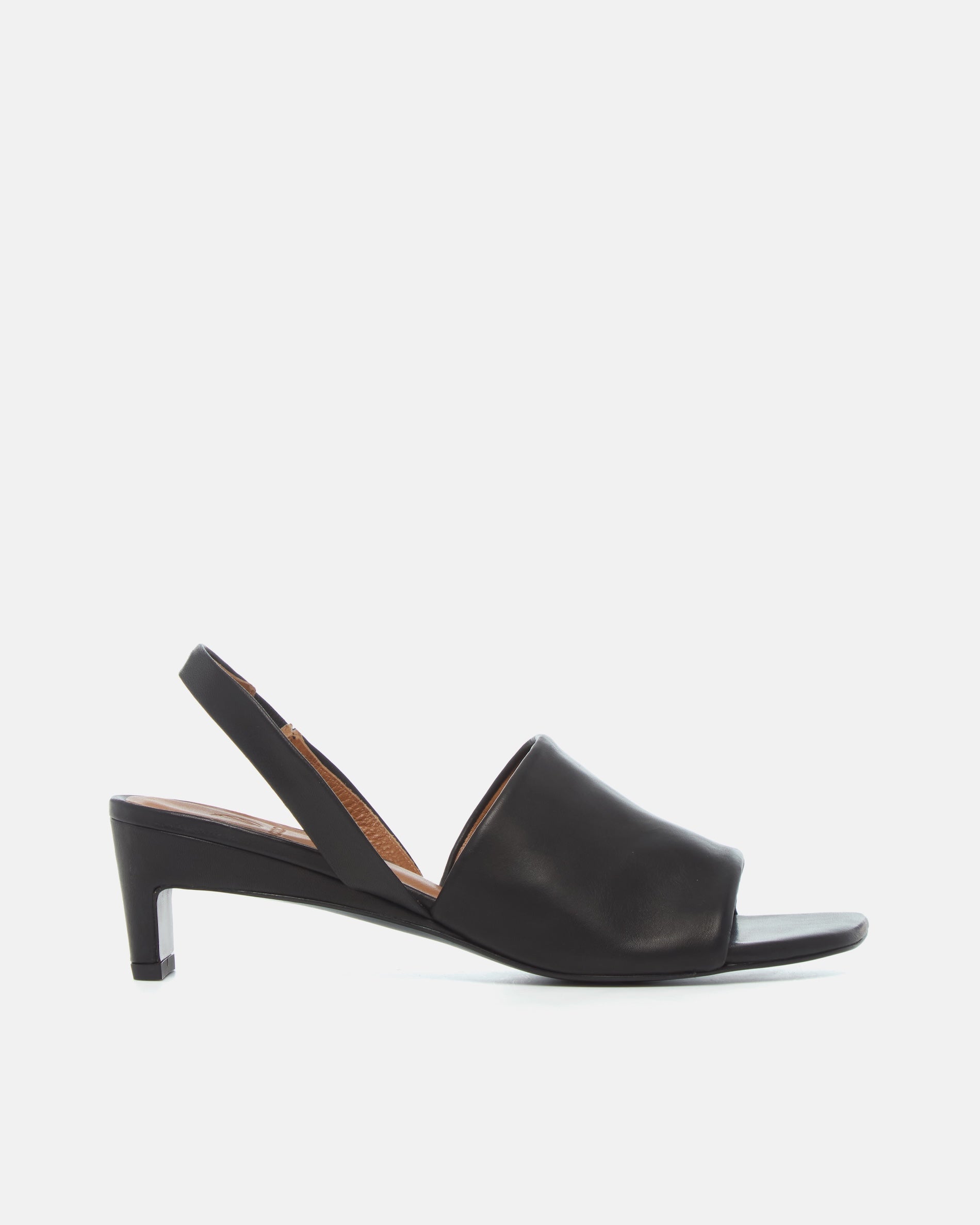 Side view of a black leather mid-heel sandal with a wide band, delicate slingback, squared toe, and sculptural block heel