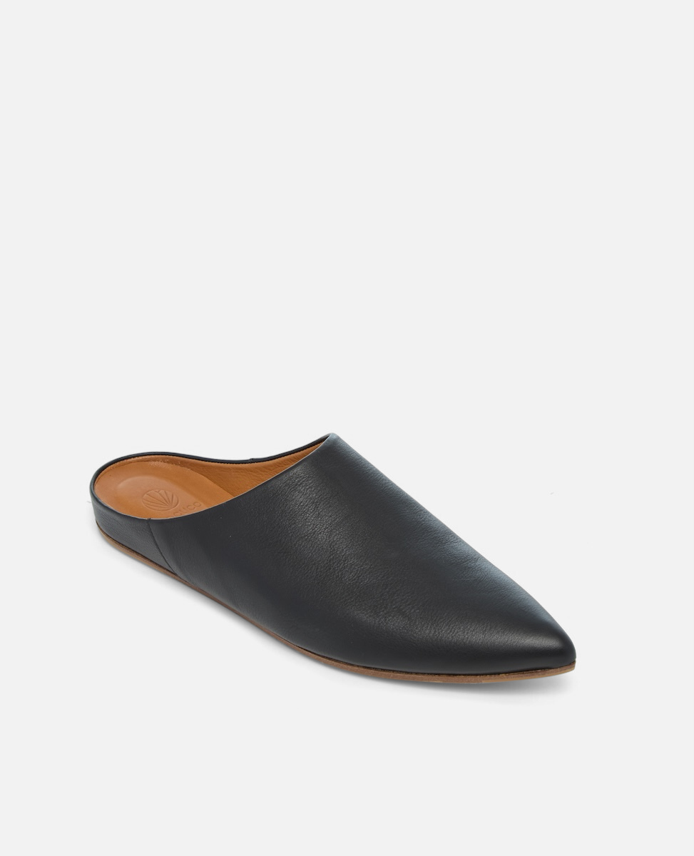 Angled view of a black pointed-toe leather mule with a slight built-in wedge and clean minimalist silhouette on a white background