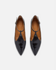 Black patent leather shoes with brown insoles on a white background 1