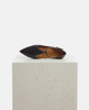 Black flat shoe with a strap on a light gray pedestal against a white background 4