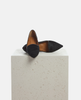 Pair of black and brown pointed-toe shoes on a light gray surface with a white background 4