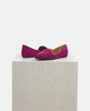 Pair of pink suede shoes on a light gray pedestal against a white background 4