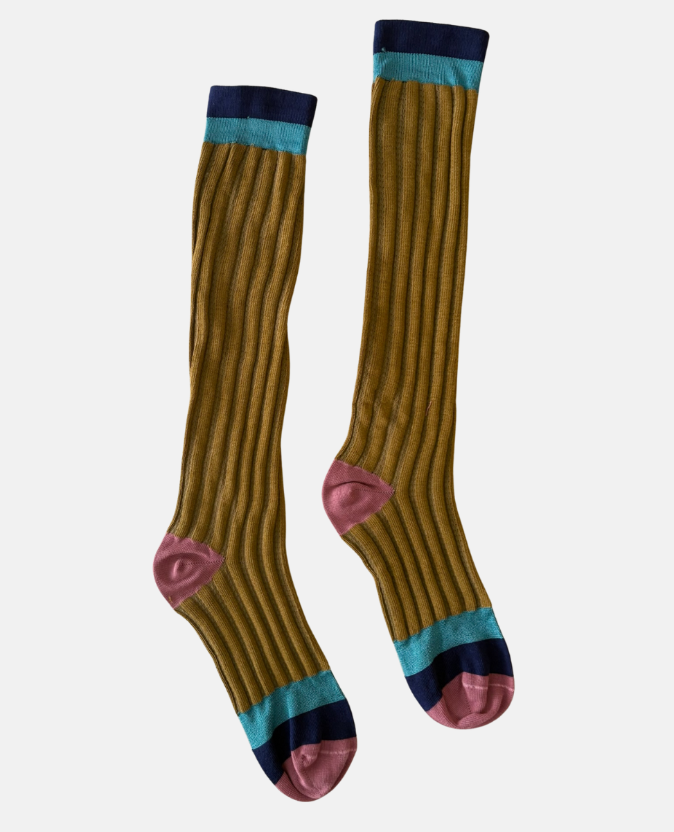 Pair of mustard yellow knee-high socks with blue and pink accents on a white background