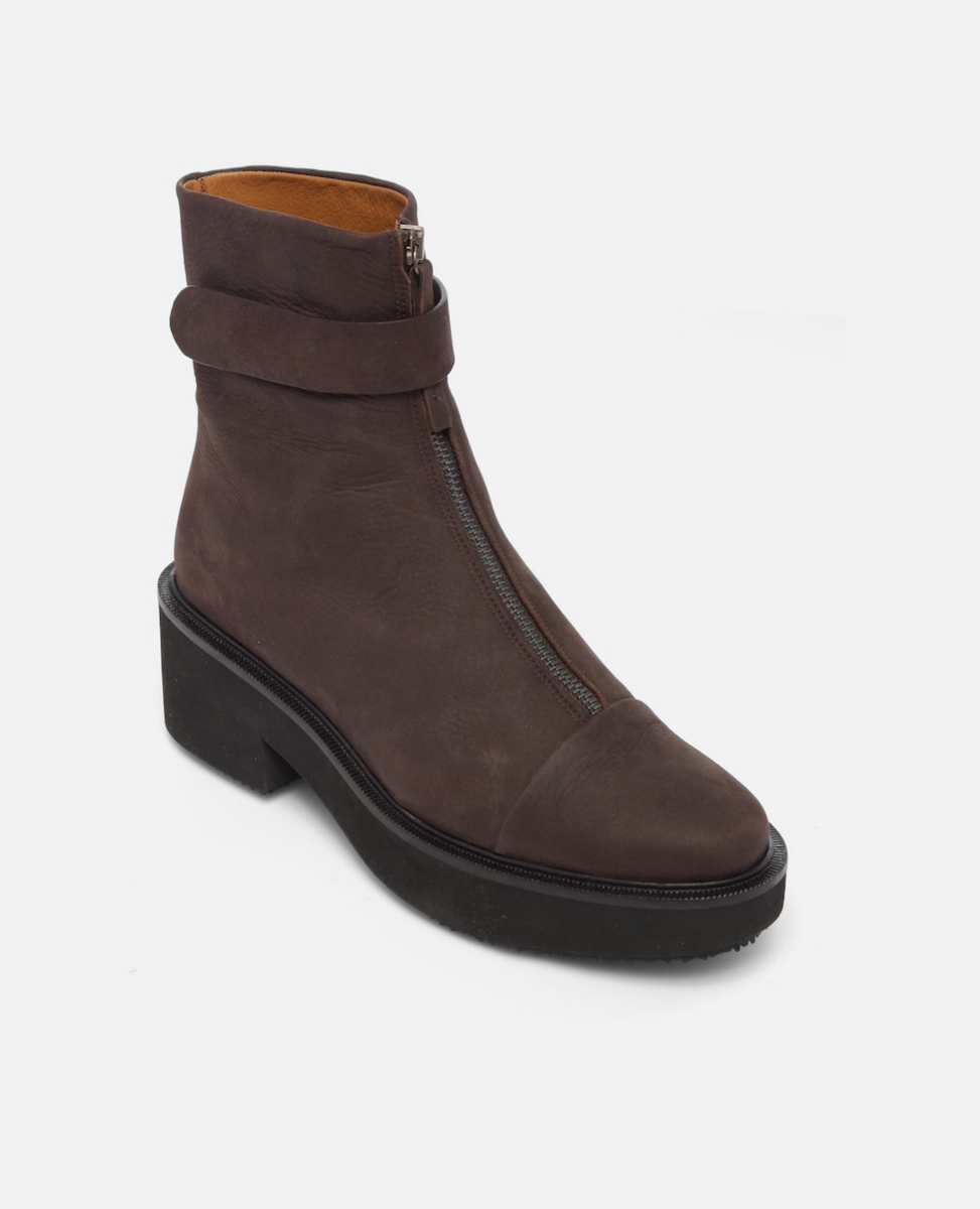 Brown ankle boot with a strap and zipper on a white background