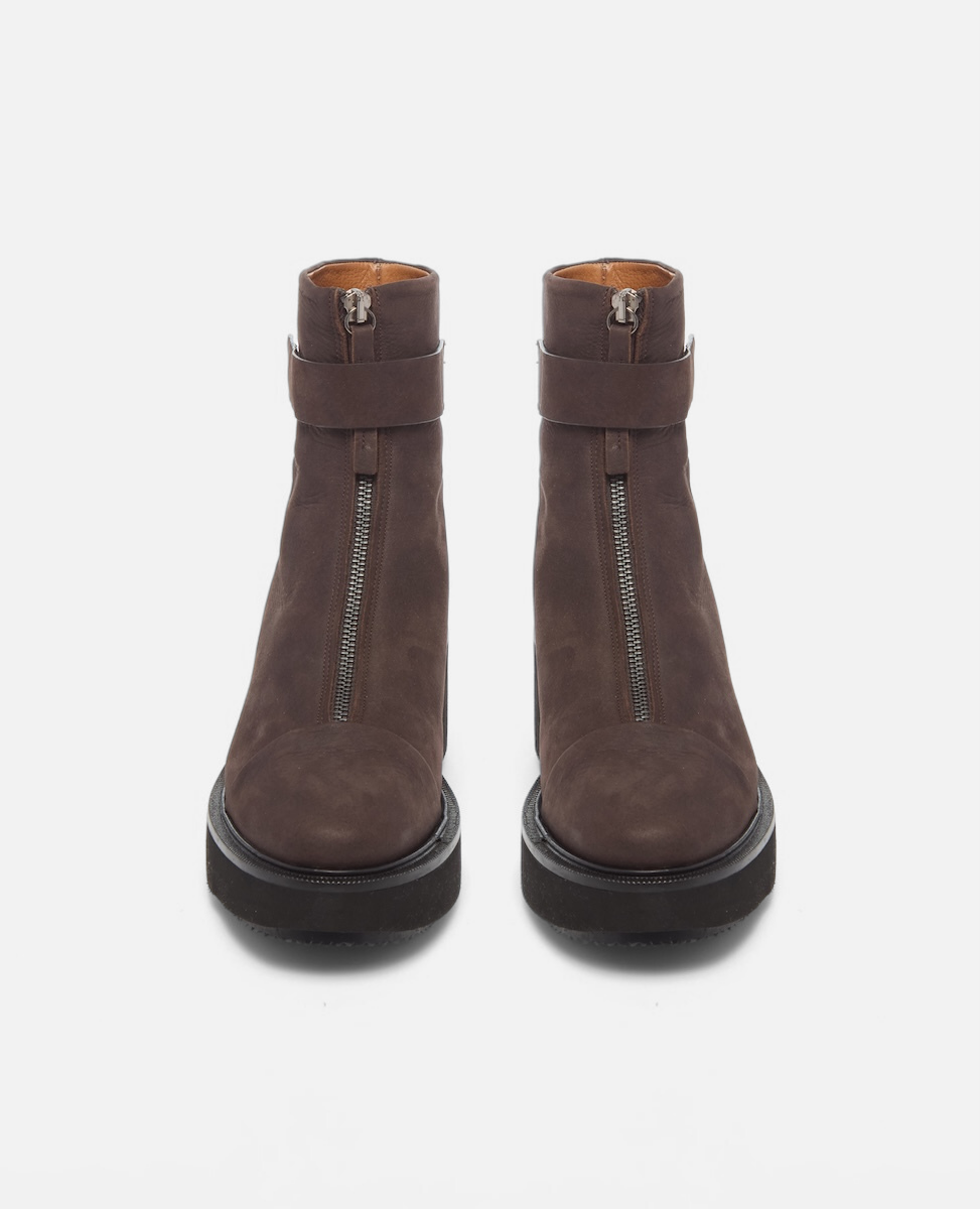 Pair of brown suede ankle boots with zippers on a white background