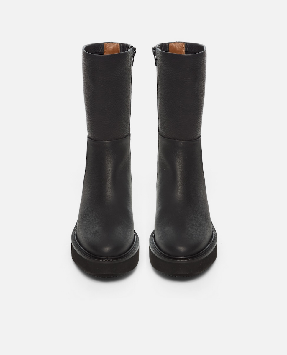 Pair of black knee-high boots on a white background