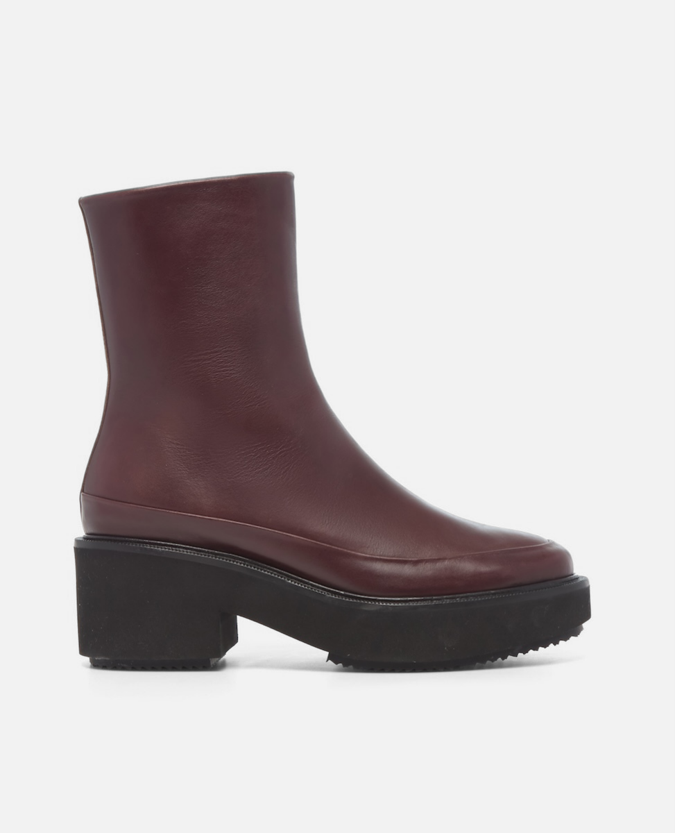 Maroon ankle boot with a chunky sole on a white background