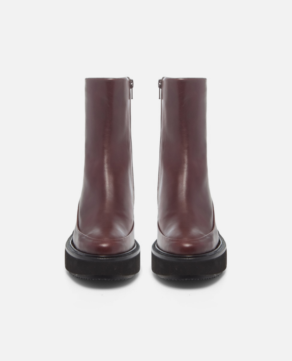 Pair of burgundy boots on a white background