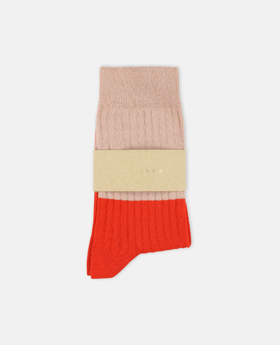 Escuyer Color-blocked sock with beige and red sections on a white background