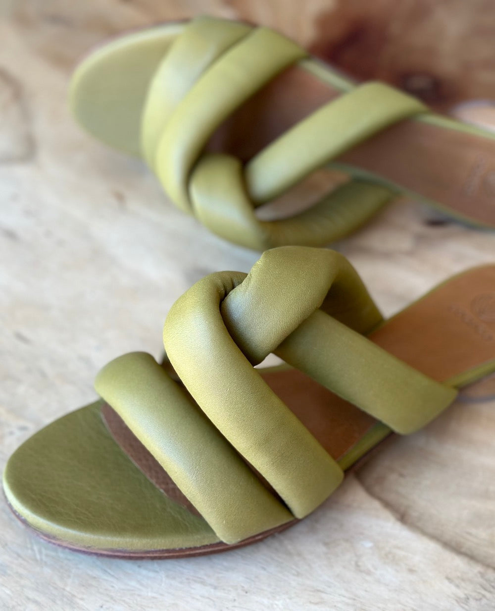 Close up of the Coclico Everly Sandal in Torbollino Olive leather showing the padded straps that twist over the arch.