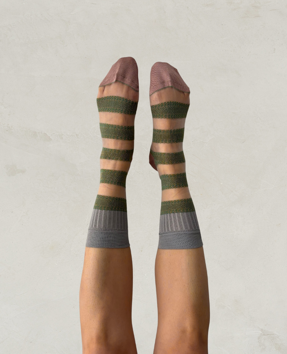 Exquisite J Striped and trnsparen socks worn by a person on a plain background