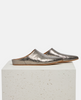 Pair of metallic silver shoes on a white pedestal against a white background 4
