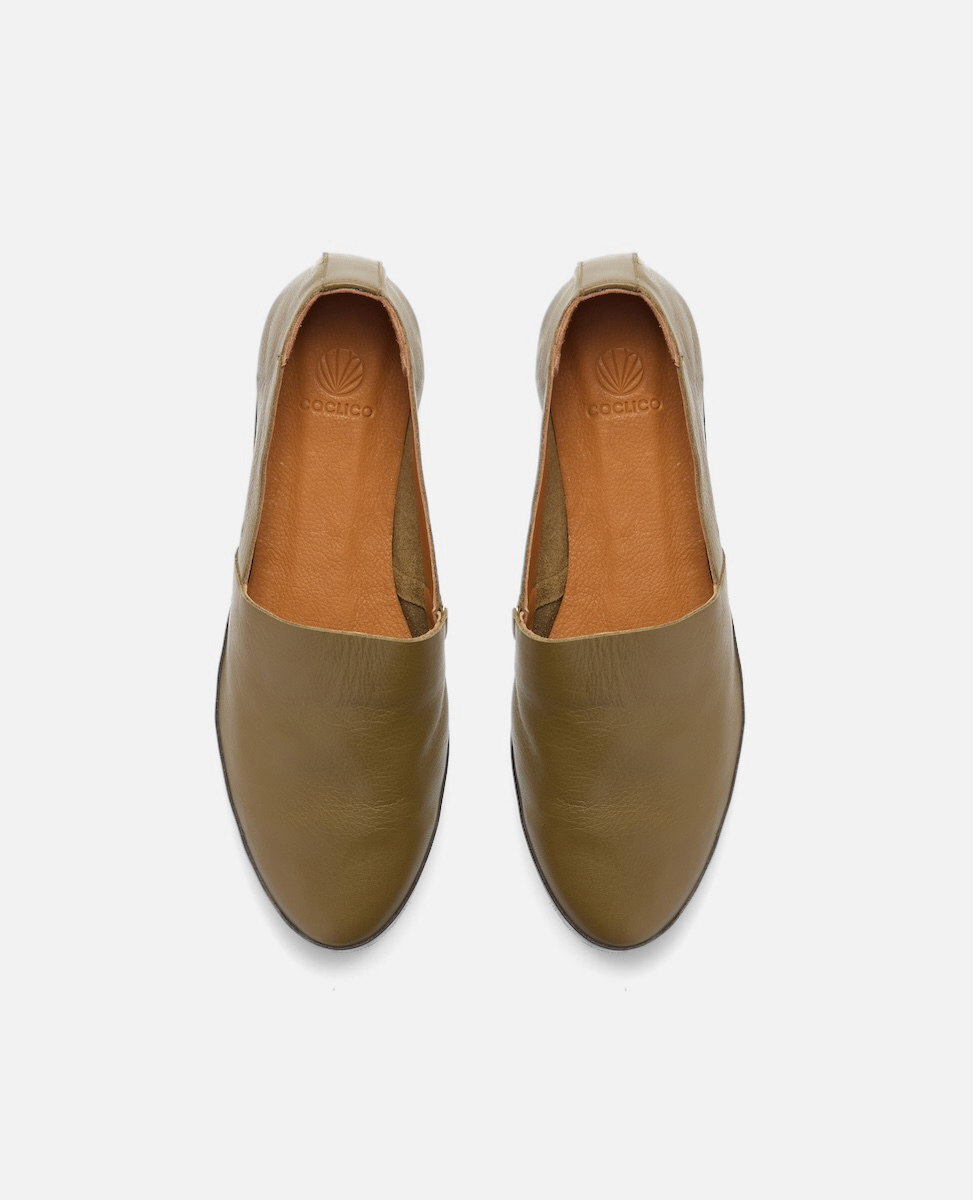 Pair of olive green shoes on a white background