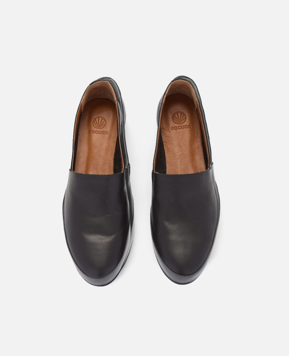 Pair of black leather shoes on a white background