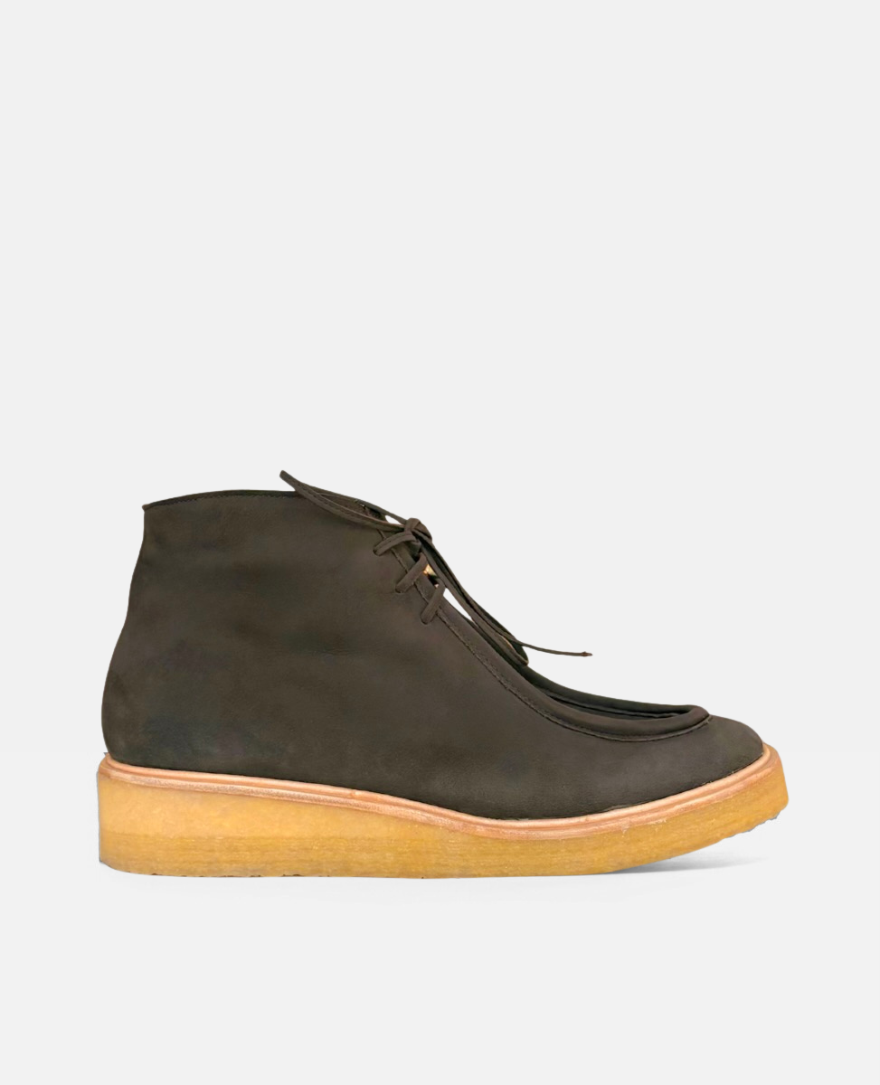 Dark brown suede chukka boot with a natural crepe sole on a white background
