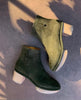 Side view of a clog bootie in split suede with a deep olive hue 3