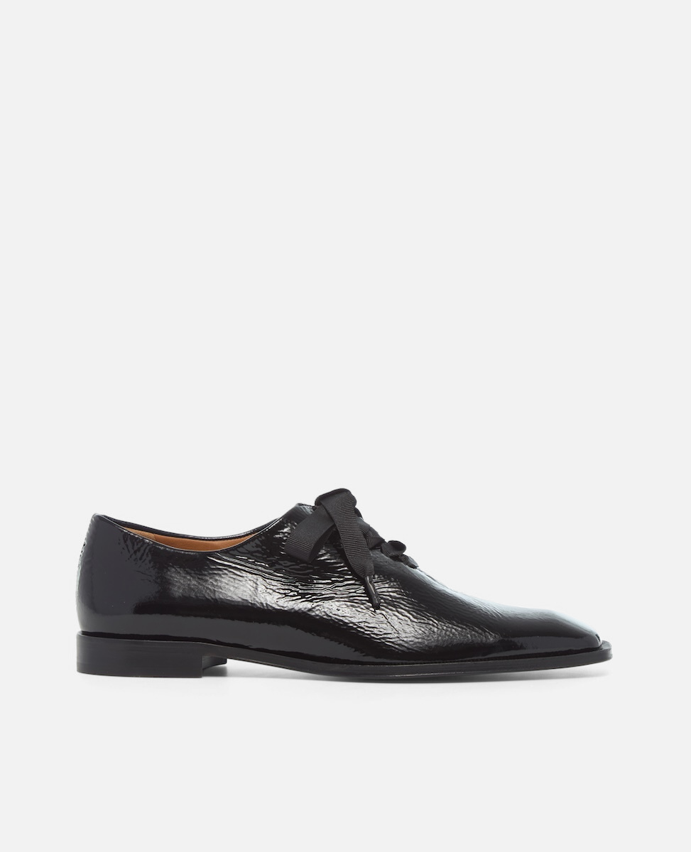 Black patent leather shoes on a white background