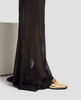 Black sheer pants with gold shoes on a light gray background 5