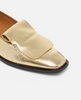 Gold loafer shoe on a white background 3