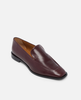 Burgundy loafer shoe on a light gray background 3