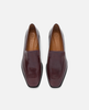 Pair of maroon loafers on a light gray background 1