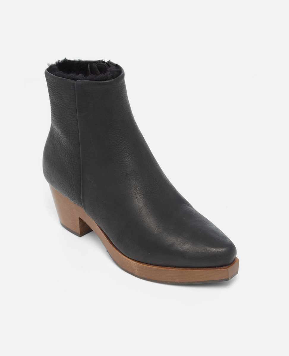 Black ankle boot with brown sole on a white background