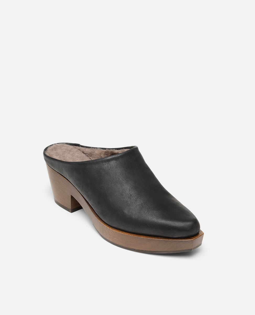 Black leather clog shoe with wooden sole on a white background