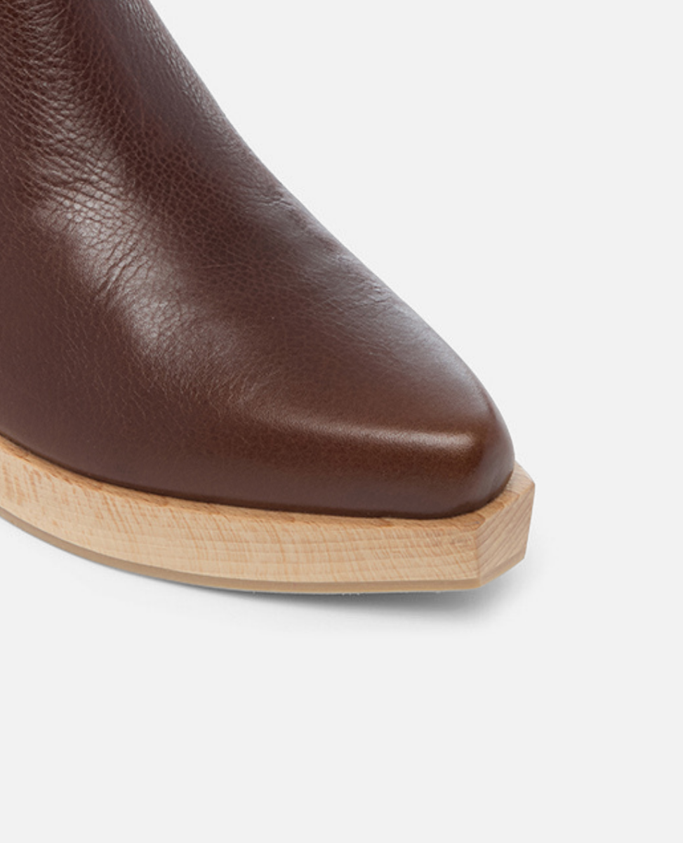 Brown leather ankle boot with wooden sole on a light gray background