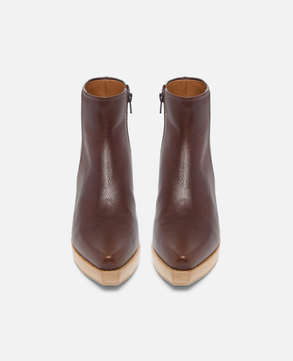 Pair of brown leather ankle boots on a white background