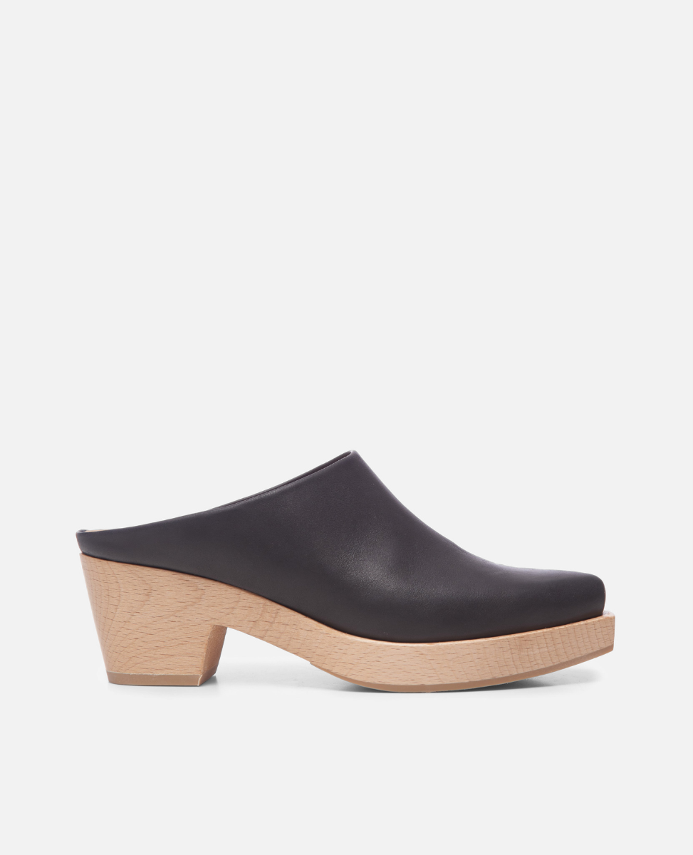 Black clog shoe with a wooden sole on a white background