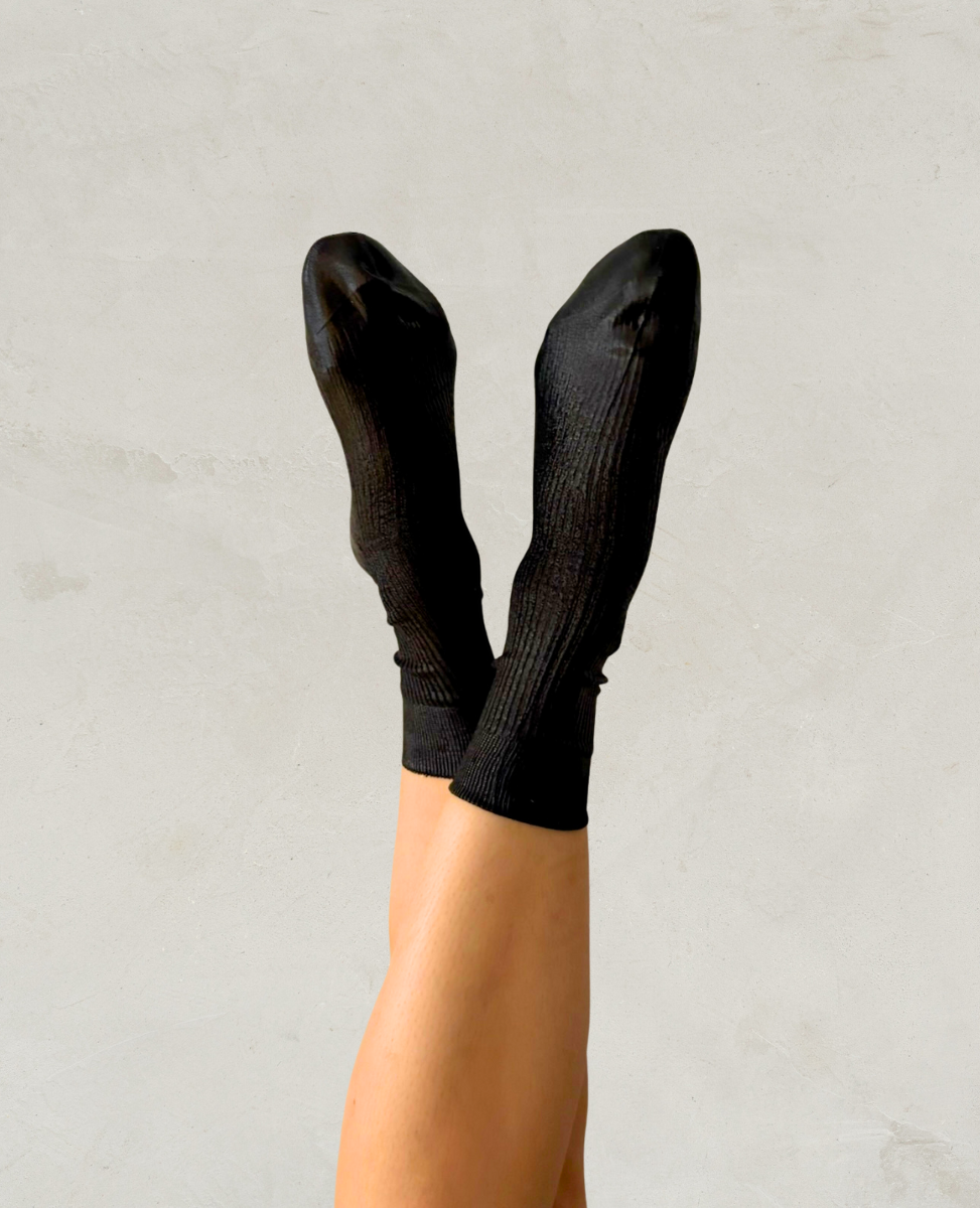 Maria La Rosa Metallic Black socks worn by a person against a light gray background