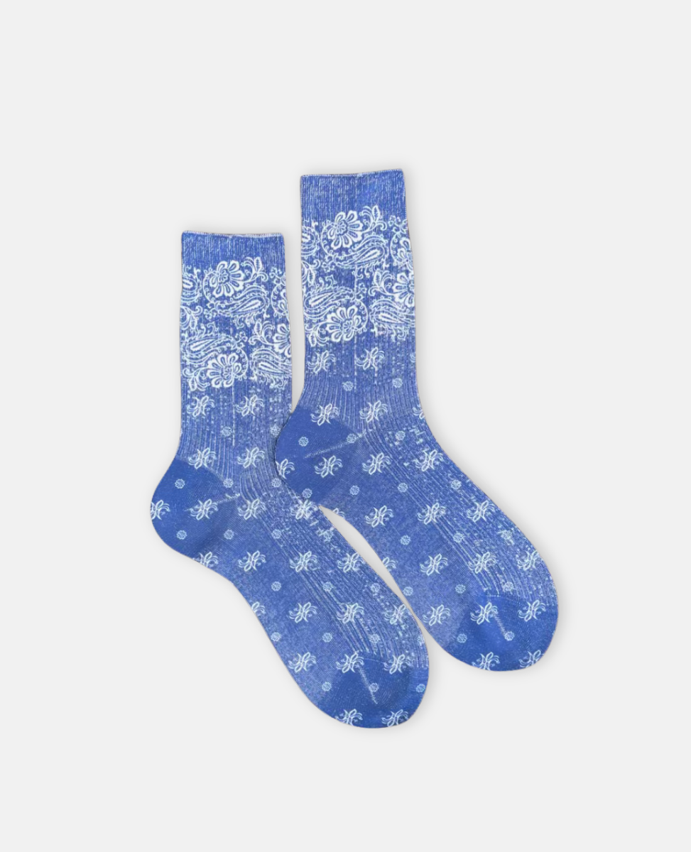 Pair of bue socks with white paisley bandana pattern on a light gray background