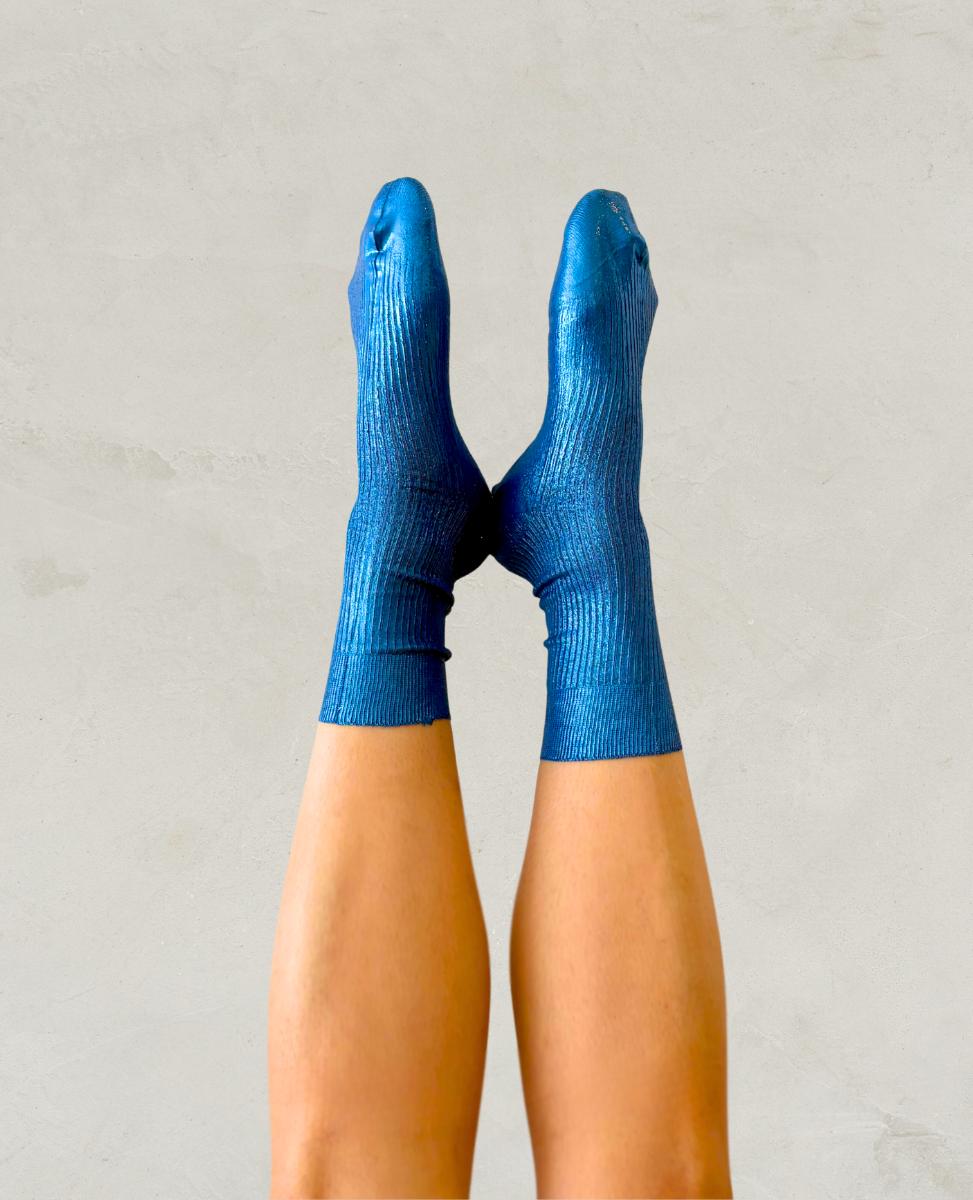 Pair of metallic foil royal blue silk socks by Maria La Rosa shown on the foot