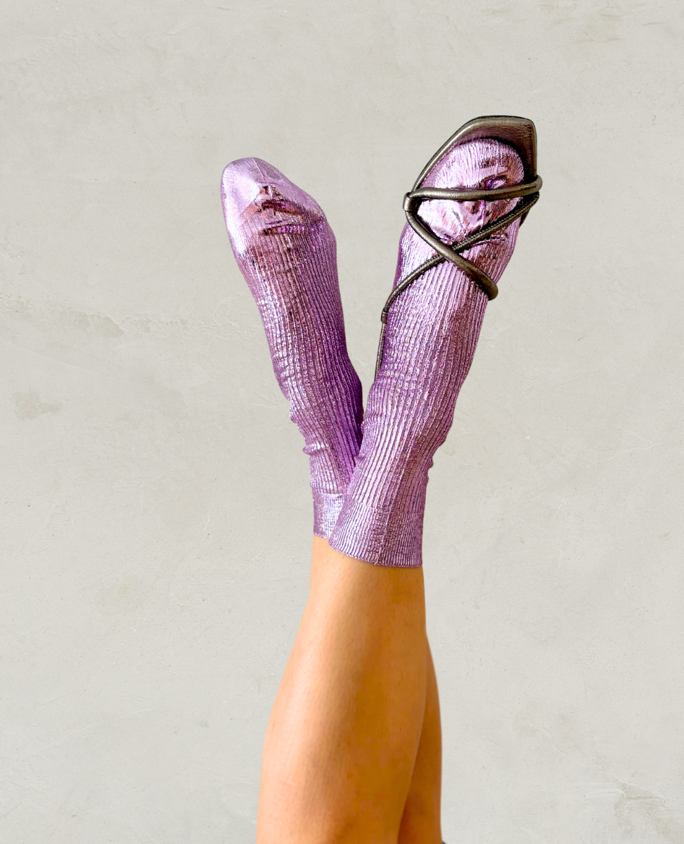 Pair of metallic foil lilac silk socks by Maria La Rosa shown on the foot with Coclico pewter sandals