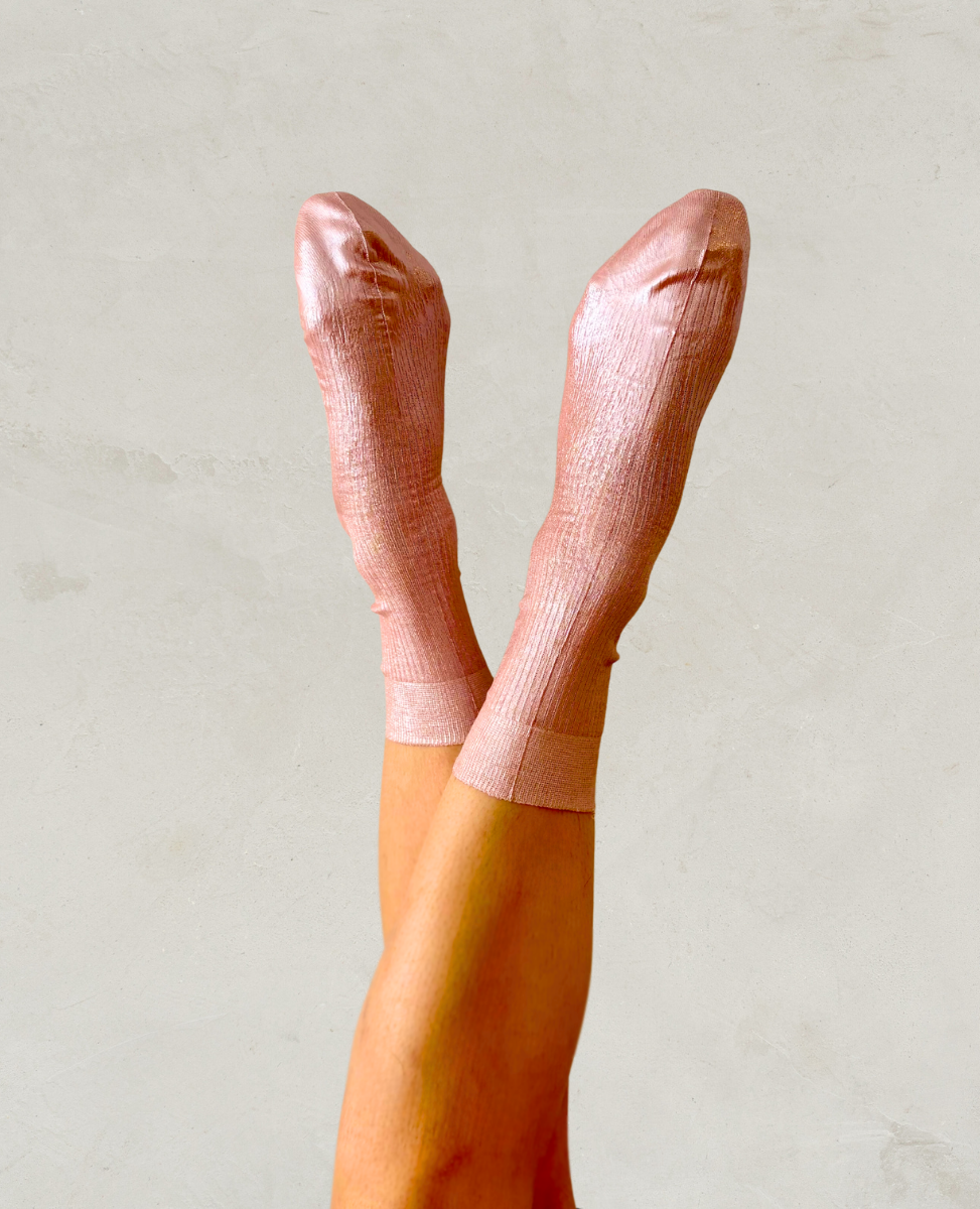 Pair of metallic foil pale pink silk socks by Maria La Rosa shown on the foot