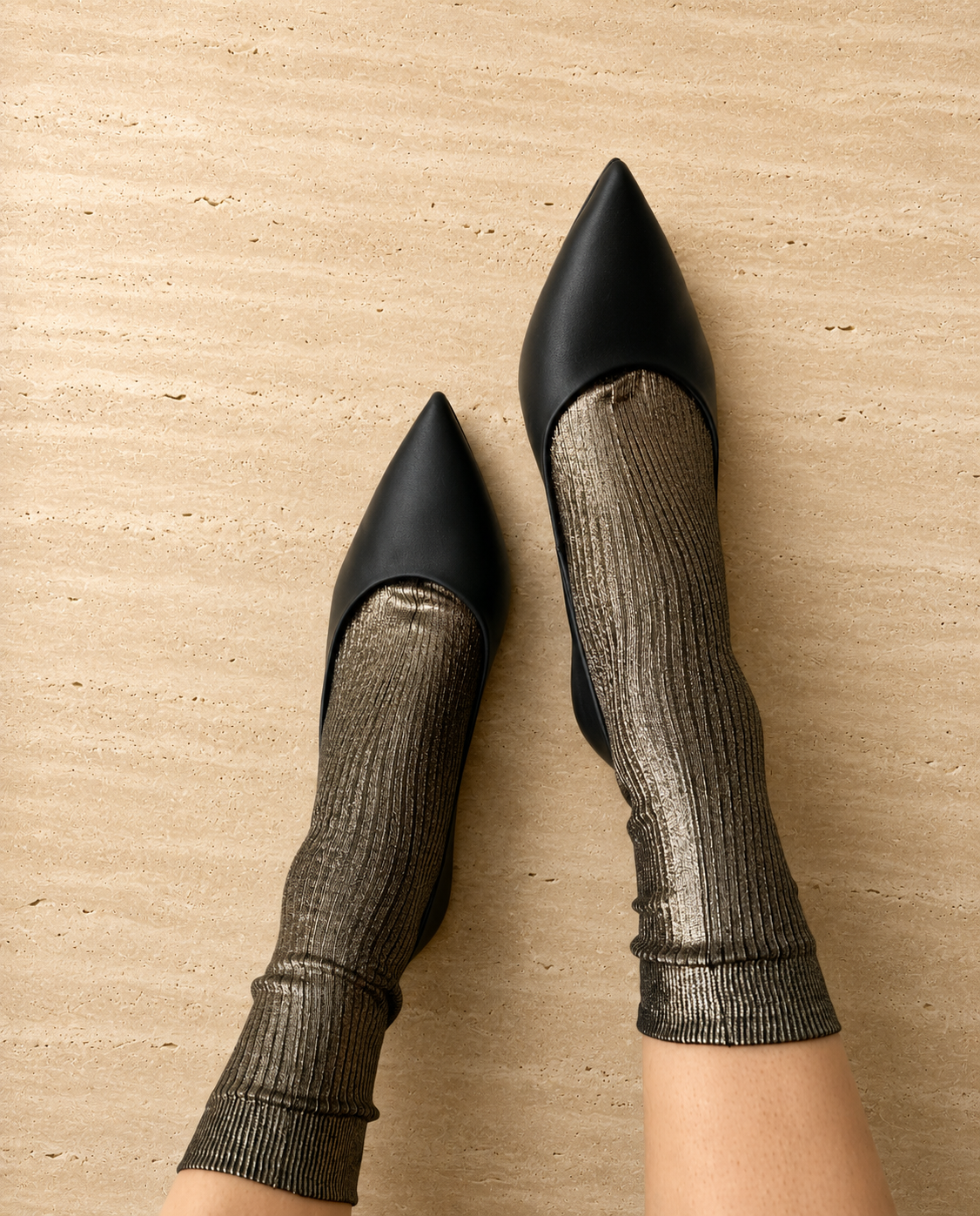 metallic grey socks worn with black pointed shoes