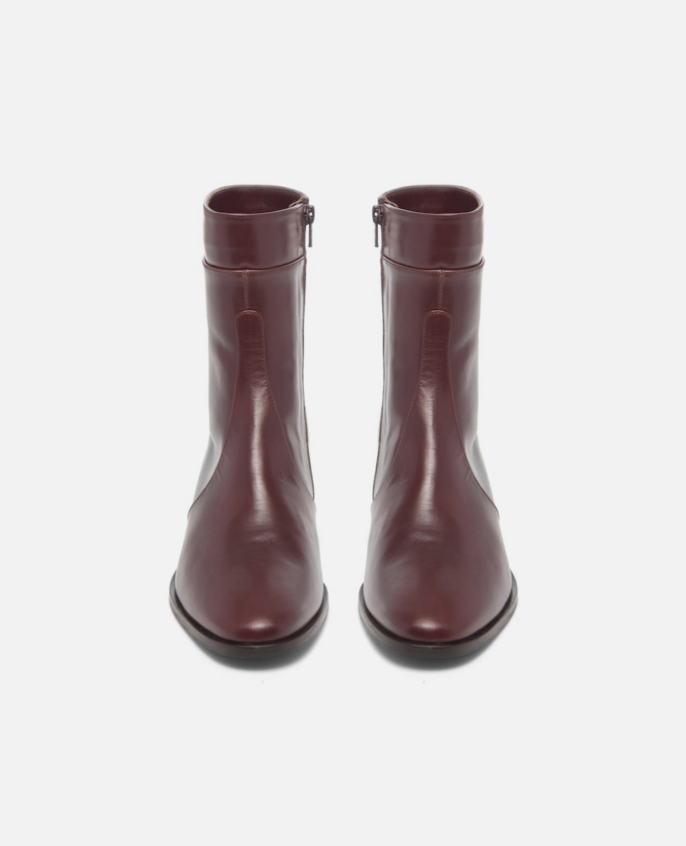 Pair of burgundy boots on a white background